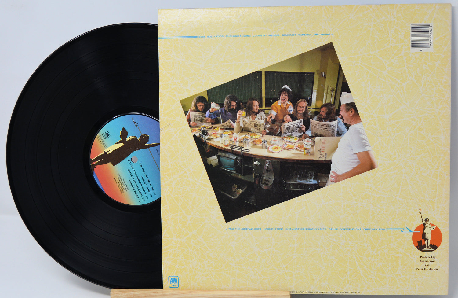 Vinyl record with cover featuring a group of people around a table.