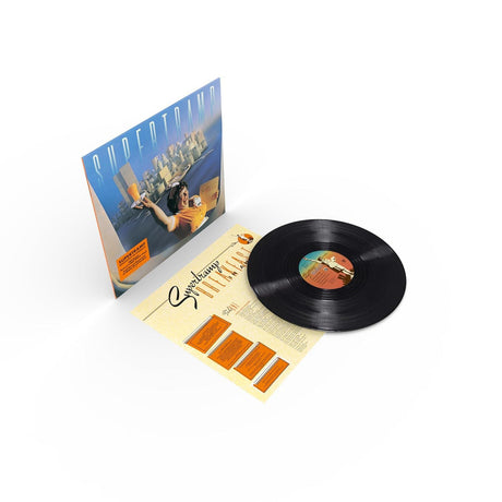 Vinyl record with cover and additional material on a white background