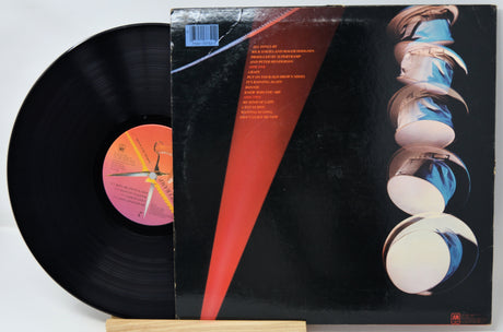 Vinyl record with colorful cover and black disc on a white background