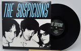 Vinyl record and cover titled 'The Suspicions' with black and white portrait on cover