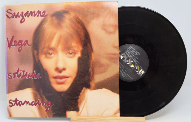 Used vinyl record of Suzanne Vega - Solitude Standing with the album cover showing the artist's face.