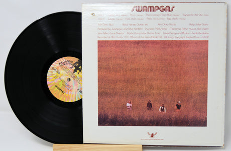 Back cover of Swampgas vinyl LP with band credits and four band members standing in a field