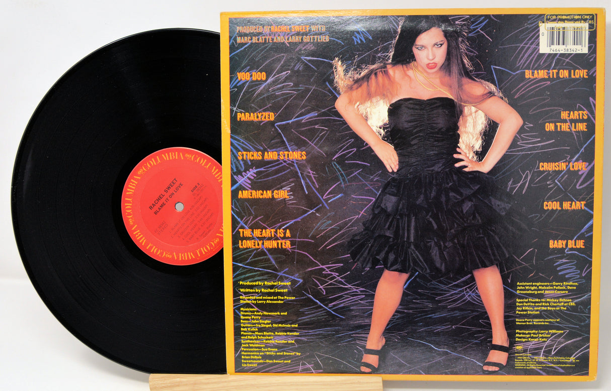 Vinyl record with a colorful cover featuring a woman in a black dress.