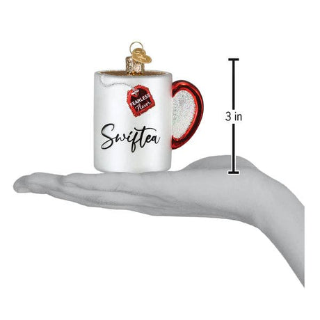 Hand holding a Swiftea mug ornament with 'Fearless Flavor' tea tag, 3 inches tall