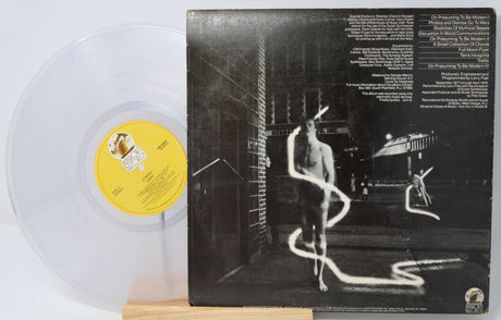Clear vinyl record with a black and white album cover featuring a person and snake.