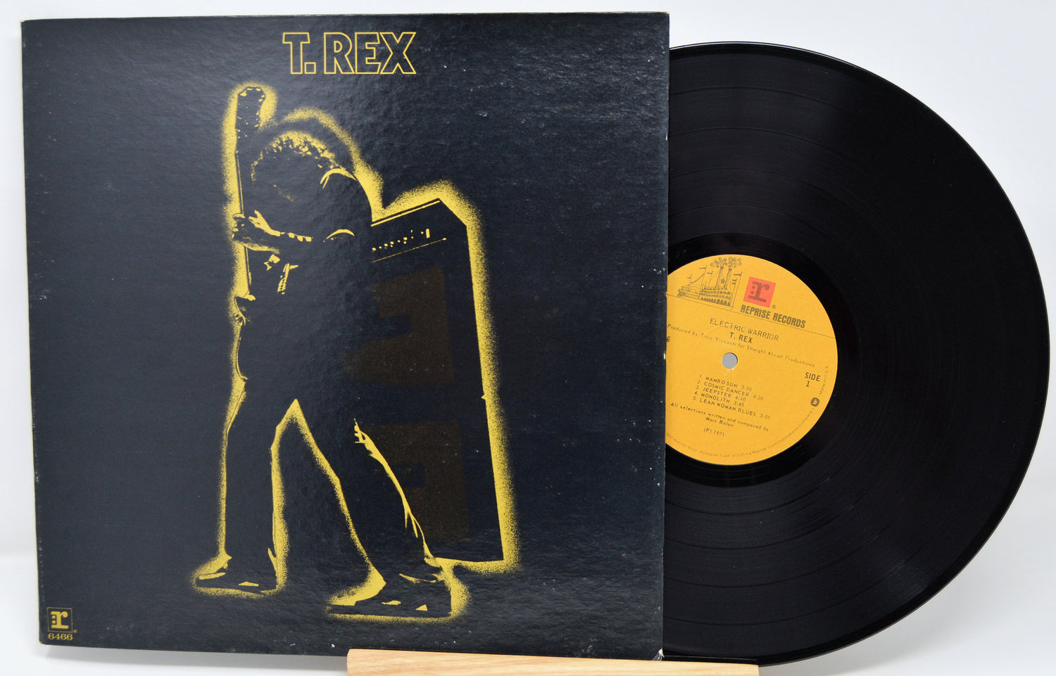 Vinyl record with a black cover featuring a yellow silhouette and 'T.Rex' branding.