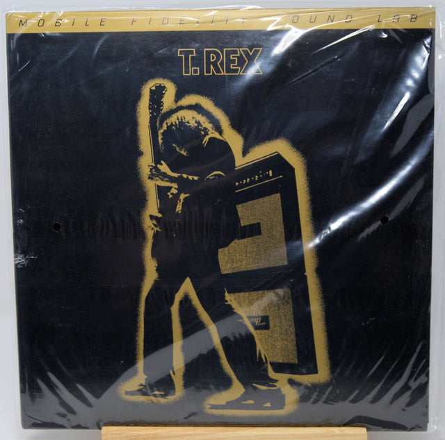T. Rex 'Mobile Fidelity Sound Lab' vinyl record cover, sealed in its original plastic shrink wrap, displayed on a small wooden stand against a white background.