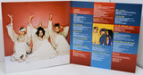 Vinyl record cover with a group of people on the left and text on the right.