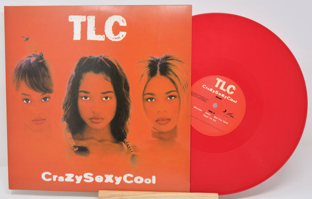 Red vinyl record with 'TLC' cover featuring three women's faces on an orange background