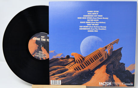 Vinyl record with a blue cover featuring an orange spaceship and desert landscape.