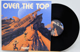 Vinyl record with 'Over The Top' album cover featuring a desert scene and airplane.