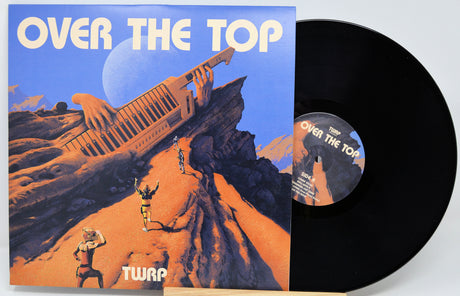 Vinyl record with 'Over The Top' album cover featuring a desert scene and airplane.
