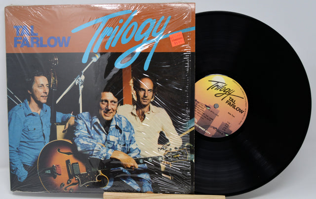 Vinyl record with cover featuring 'Til Farlow Trilogy' on a gray background