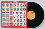 Front cover of Talking Drums 'Some Day Catch Some Day Down' vinyl record with vivid artwork
