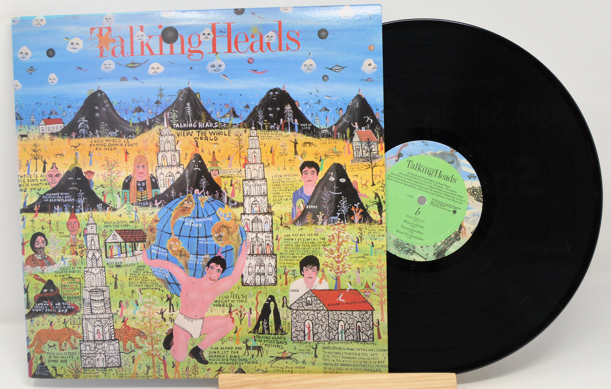 Vinyl record with a colorful cover featuring 'Talking Heads' and a person holding a globe.