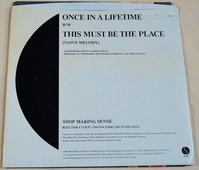 Back cover of Talking Heads Once in a Lifetime vinyl single with track info.
