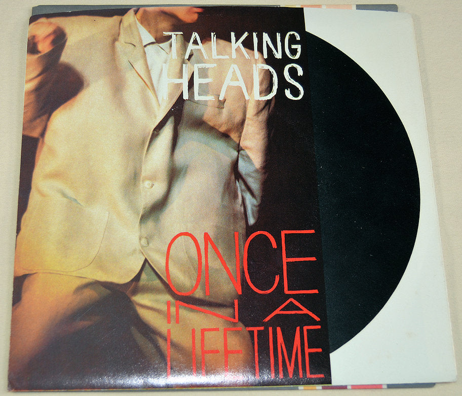 Front cover of Talking Heads Once in a Lifetime vinyl single featuring distinctive artwork.