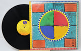 Vinyl record with a colorful cover featuring geometric patterns.