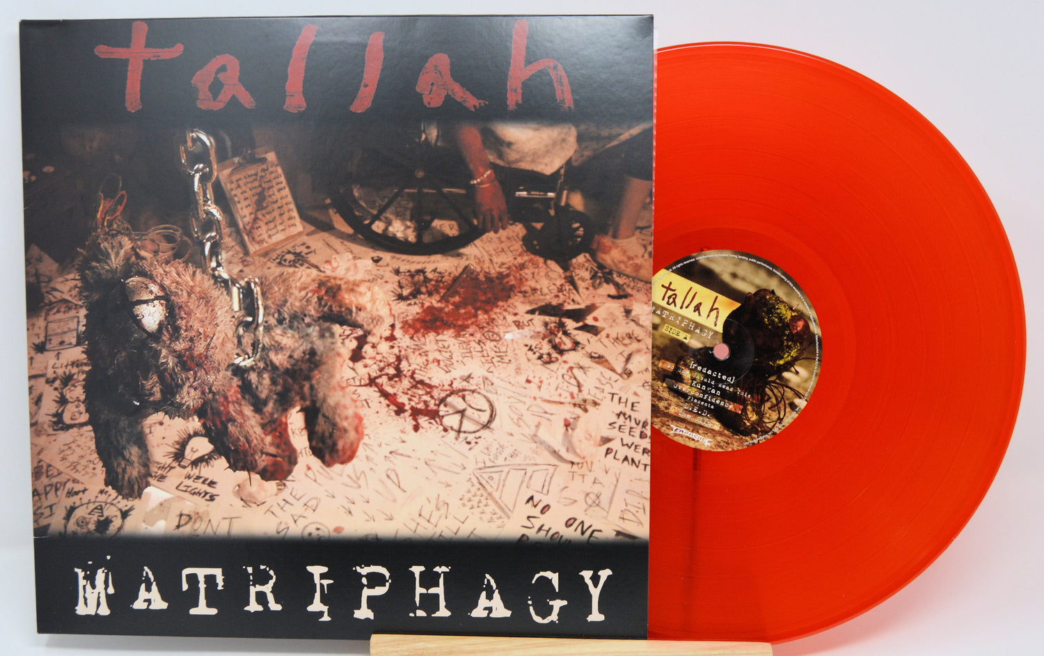 Front cover of Tallah Matriphagy LP with chained stuffed animal and splattered red floor