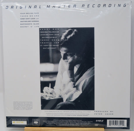 Vinyl record sleeve for Miles Davis' 'Original Master Recording' LP, sealed in plastic shrink wrap. The white cover features a large black-and-white portrait of Davis, tracklist text on the left, and a black label band at the bottom with a barcode.