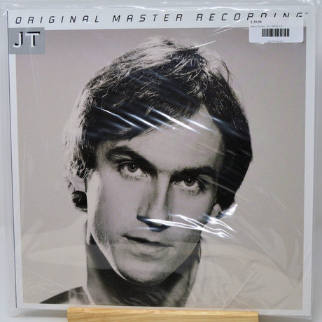 A vinyl record sleeve for Jim Morrison's 'Original Master Recording' LP, sealed in plastic wrap. The cover features a black and white portrait of Jim Morrison, with 'JT' in a gray box on the top left and a barcode sticker on the top right.