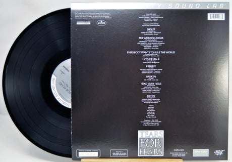 A vinyl record partially pulled from its sleeve, showing the back of the packaging. The black record is visible on the left, and the sleeve is black with white printed tracklist text and the title 'TEARS FOR FEARS' near the bottom.