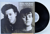 Tears For Fears - 'Songs From The Big Chair' vinyl record with the album cover on the left and the black LP record partially visible on the right against a light background.
