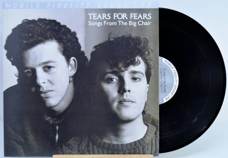 Tears For Fears - 'Songs From The Big Chair' vinyl record with the album cover on the left and the black LP record partially visible on the right against a light background.