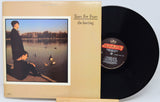 Vinyl record with cover featuring a person by a lake and album title 'The Hurting' by Tears for Fears.