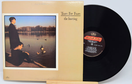 Vinyl record with cover featuring a person by a lake and album title 'The Hurting' by Tears for Fears.
