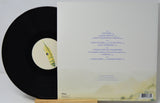 A vinyl record partially pulled from its sleeve, showing the black record with a cream center label and the back of the album cover with track listing text.