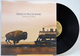 Vinyl record album for 'Made Up Mind' by the Tedeschi Trucks Band, showing the illustrated cover with a bison and train car alongside the black vinyl disc.