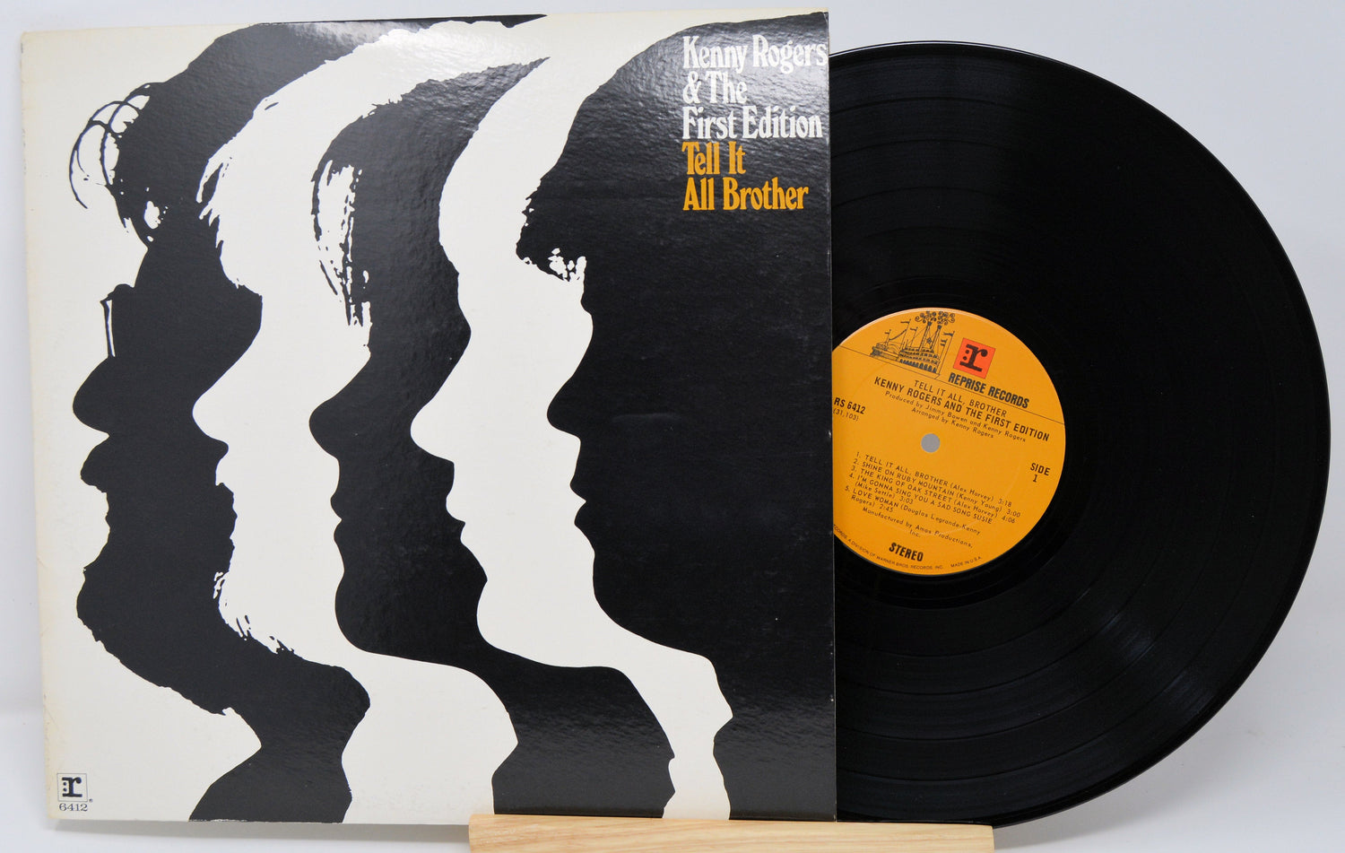 Front cover of Kenny Rogers & The First Edition's Tell It All Brother LP featuring stylized profile silhouettes and visible vinyl record