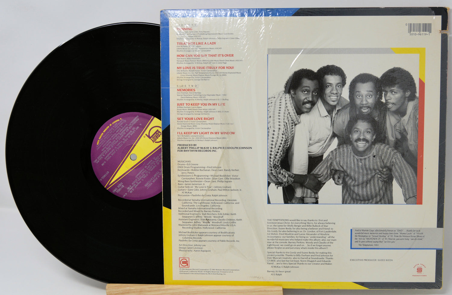 Vinyl record with cover featuring a group of people and text