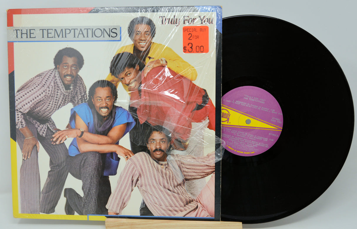 Vinyl record with cover featuring The Temptations on a white background