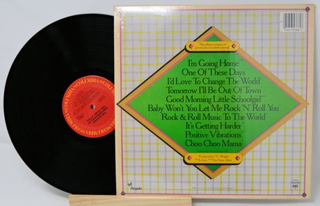 Vinyl record with cover displaying song titles on a light gray background