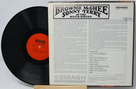 Vinyl record with cover featuring text and a red label on a white background