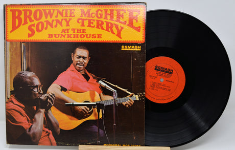 Vinyl record and cover featuring musicians with a prominent label on a white background