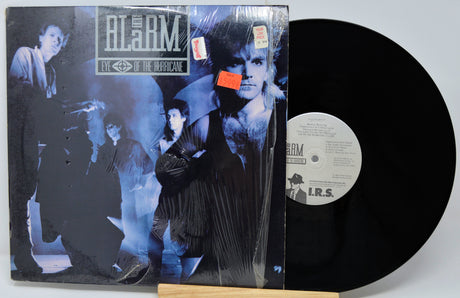 Vinyl record with cover featuring a band and text 'The Alarm' on a white background
