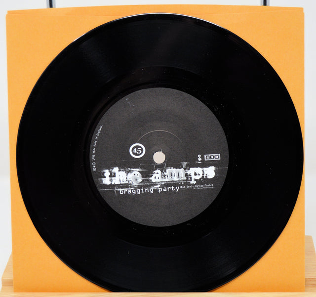 The Amps Bragging Party indie rock vinyl single in orange cover