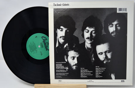 Vinyl record with a black cover featuring a band's faces and a white label.