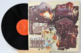 Vinyl record with a colorful album cover featuring band members and scenes.