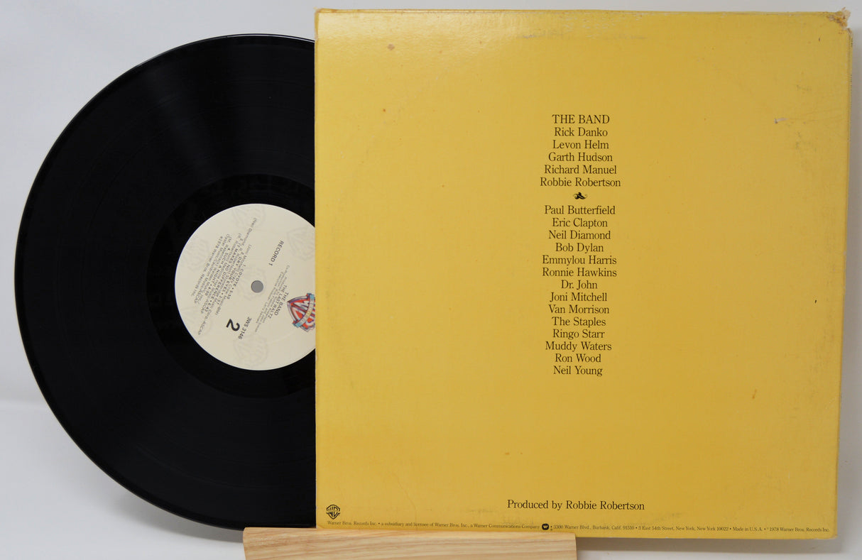 Vinyl record with yellow cover featuring album credits on a white background