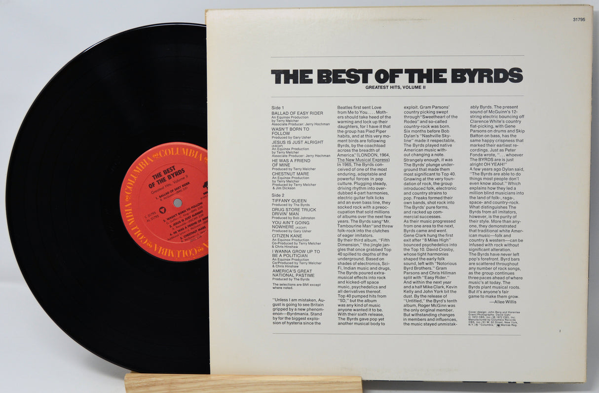 Vinyl record with a white label featuring text and a red label on a light gray background