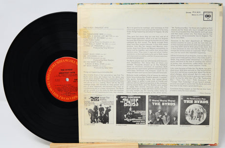 Vinyl record with cover featuring text and black and white images of band members.