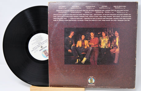 Vinyl record with cover art featuring a group of people.
