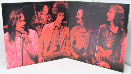 Vintage album cover with band members and pink-red color scheme.