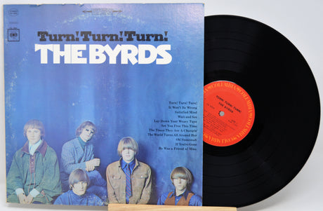 A vintage vinyl record of The Byrds' album 'Turn! Turn! Turn!' with the black LP partially pulled from the cover, photographed on a light gray background.