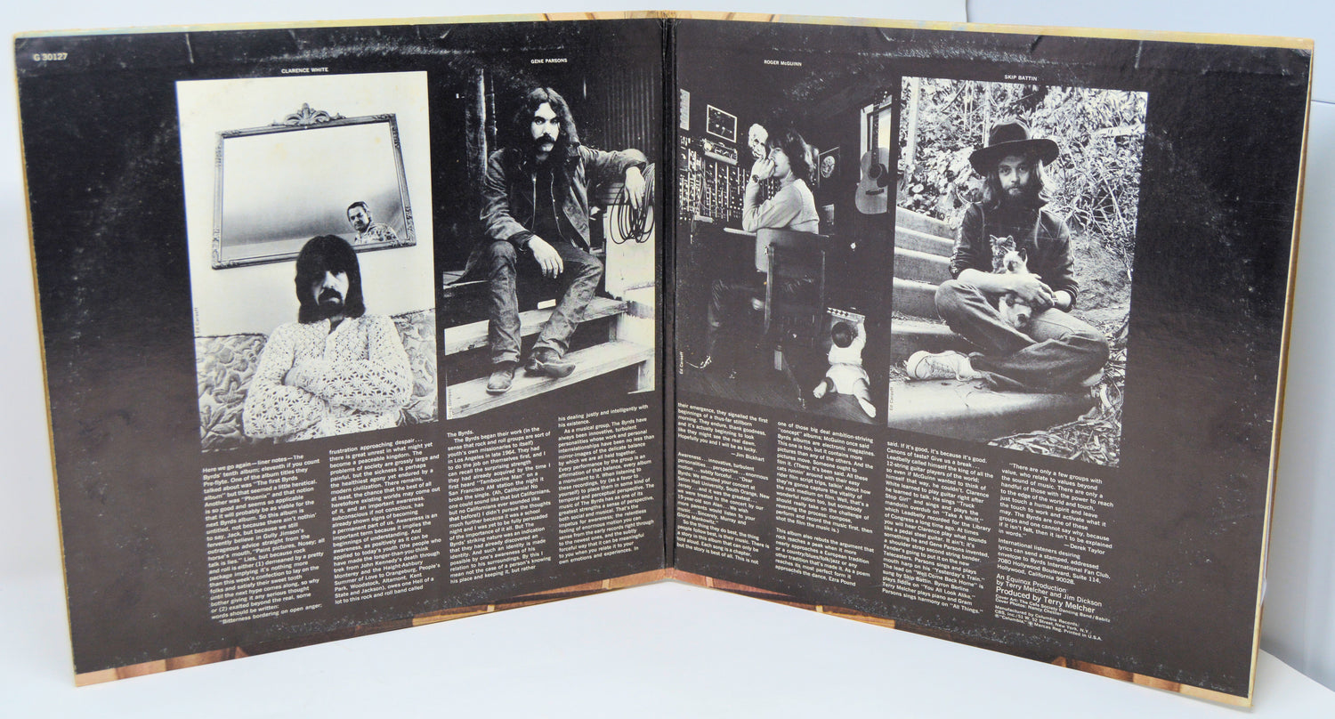 Open record gatefold with black and white photos and text.