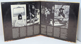 Open record gatefold with black and white photos and text.